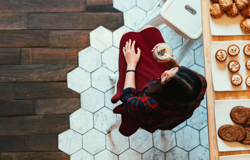 A woman siting at a bakery counter