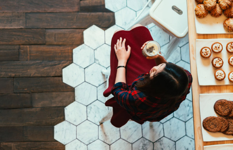 A woman siting at a bakery counter